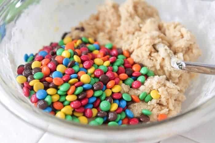 m&m's added to bowl of cookie dough