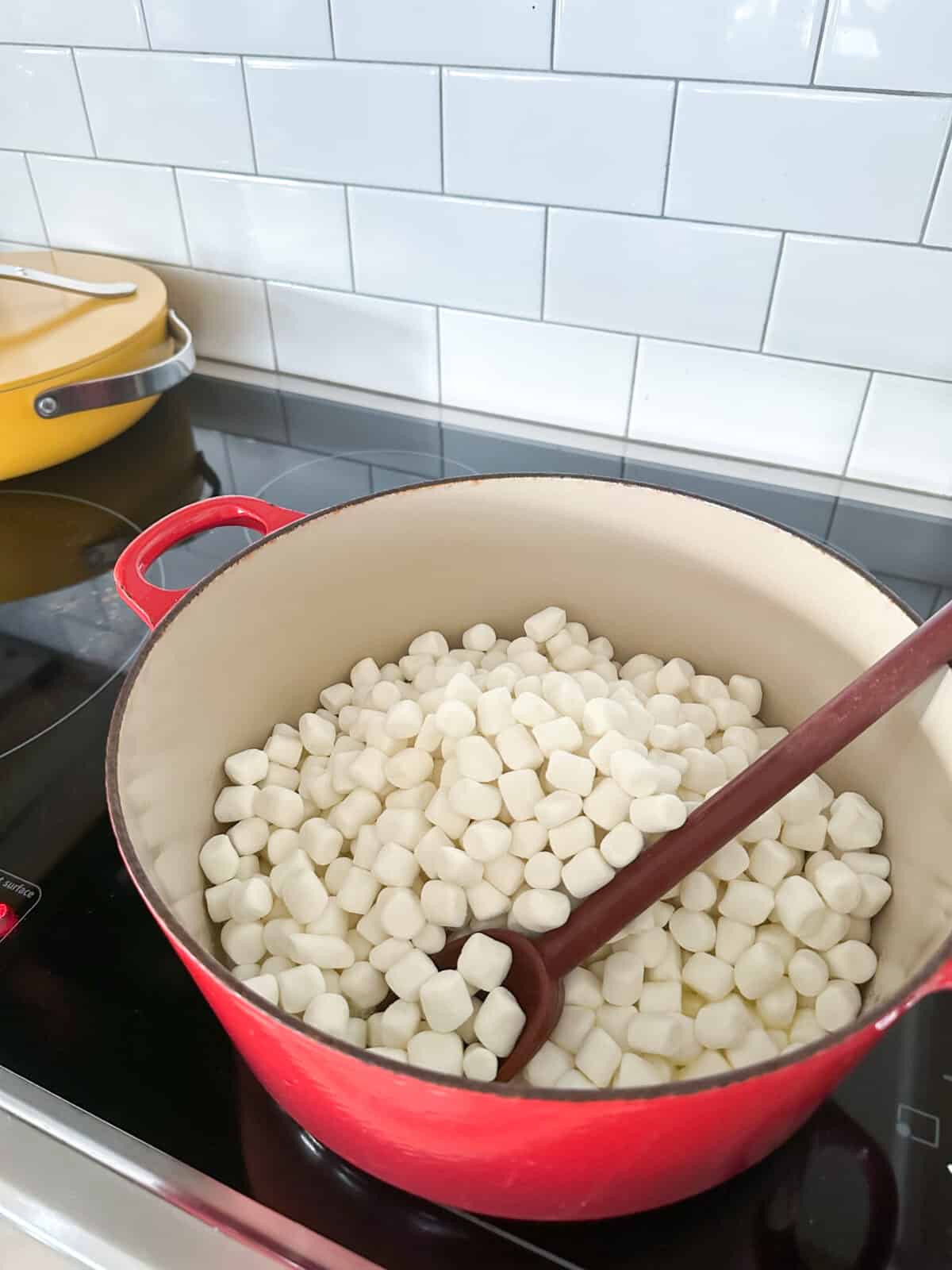 mini marshmallows added to butter in large pot on stove