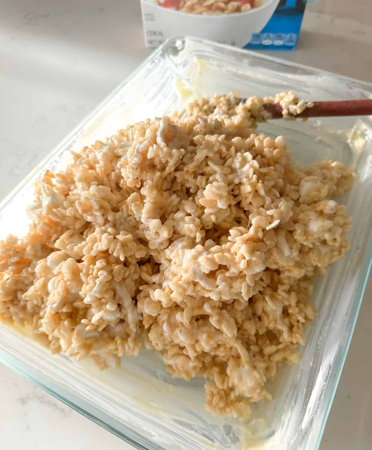 hot rice krispie treats poured into buttered pan
