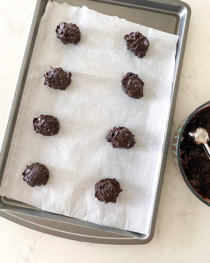 flourless cookie dough scooped into balls on baking sheet