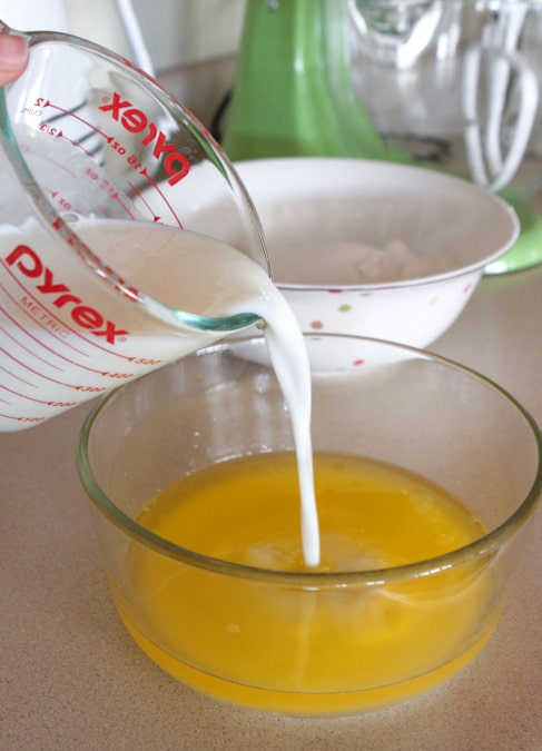pouring buttermilk into egg mixture in mixing bowl