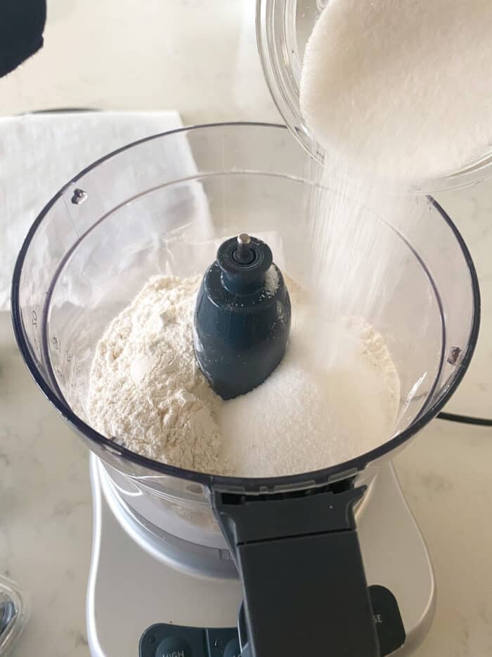 adding dry ingredients to food processor