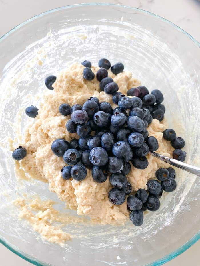 blueberries added to scone batter in mixing bowl