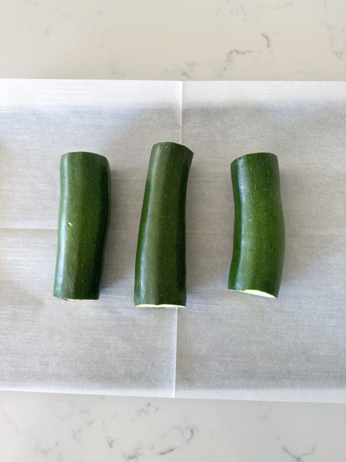 zucchini with ends cut off on baking sheet