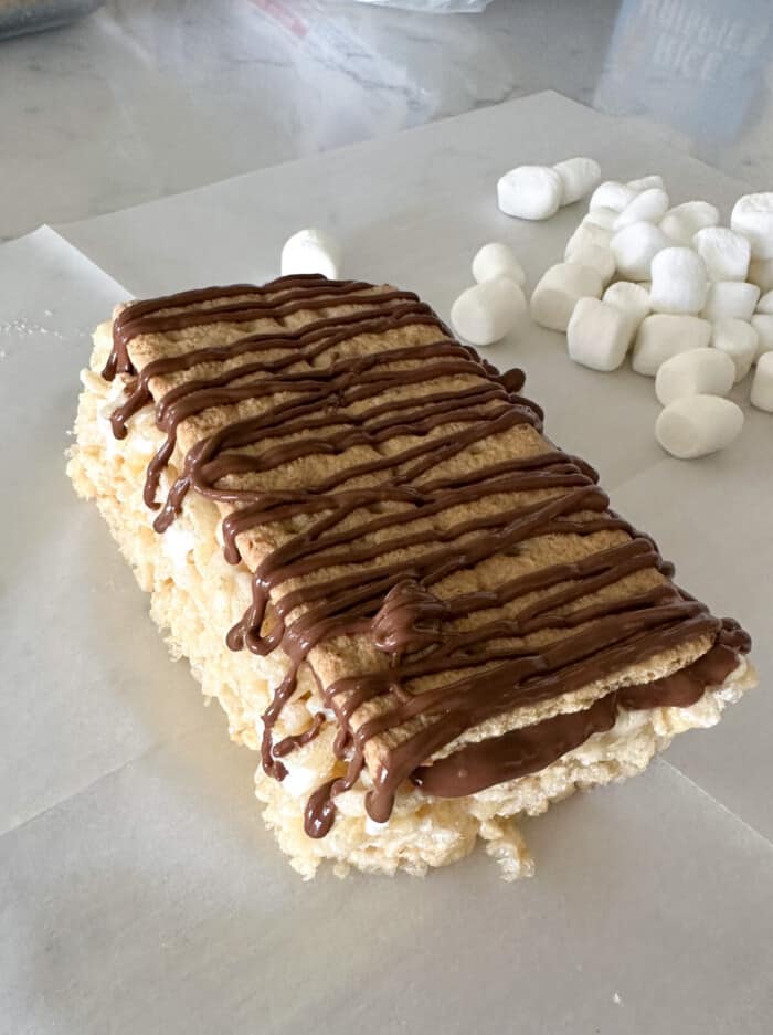 graham cracker and chocolate added to top of rice krispie treats