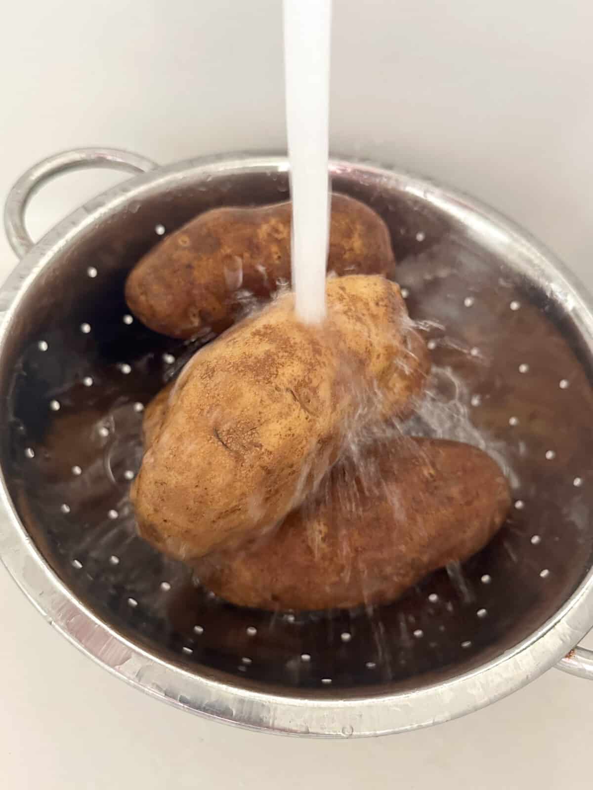 washing potatoes in colander