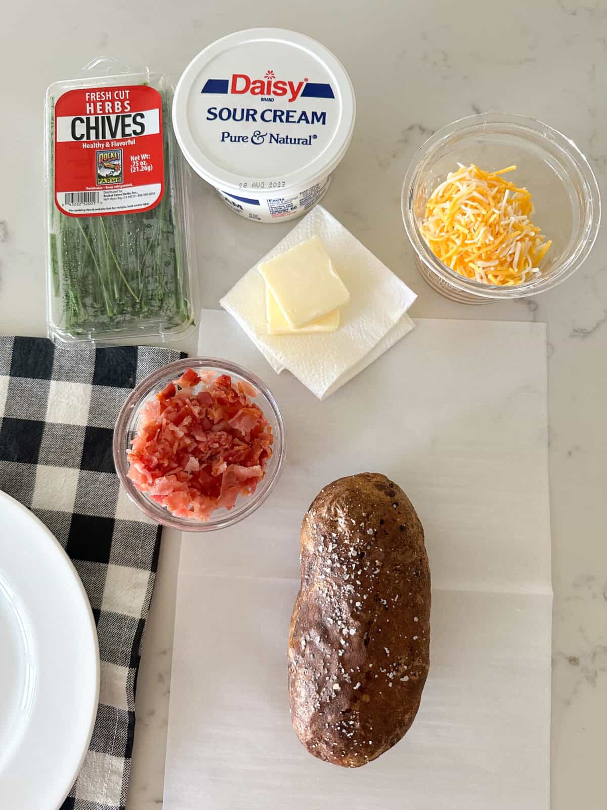 baked potato on parchment paper ready to add toppings