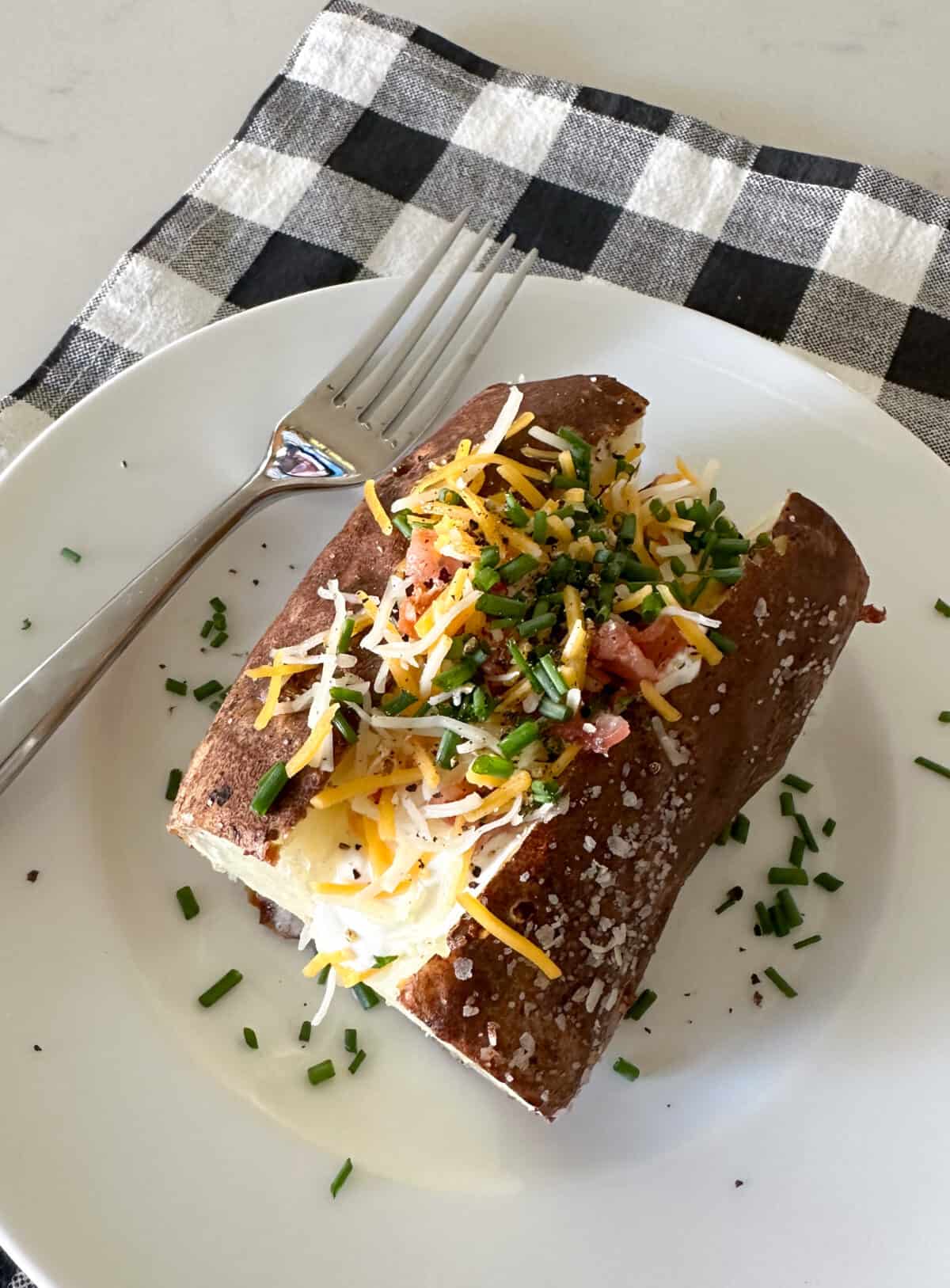 loaded baked potato on serving plate