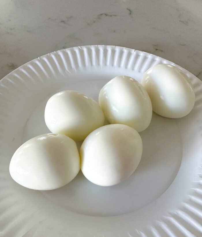 peeled hard boiled eggs on plate