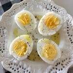air fryer hard boiled eggs cut in half on serving plate