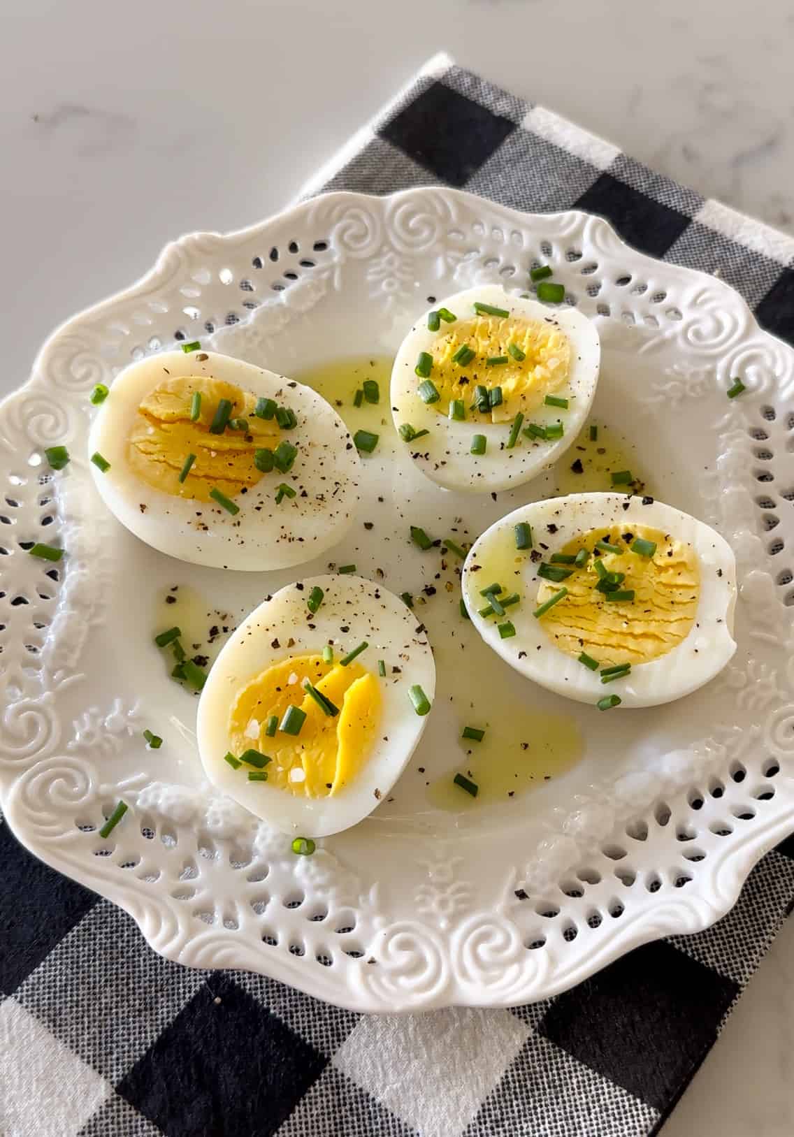 air fryer hard boiled eggs cut in half on serving plate