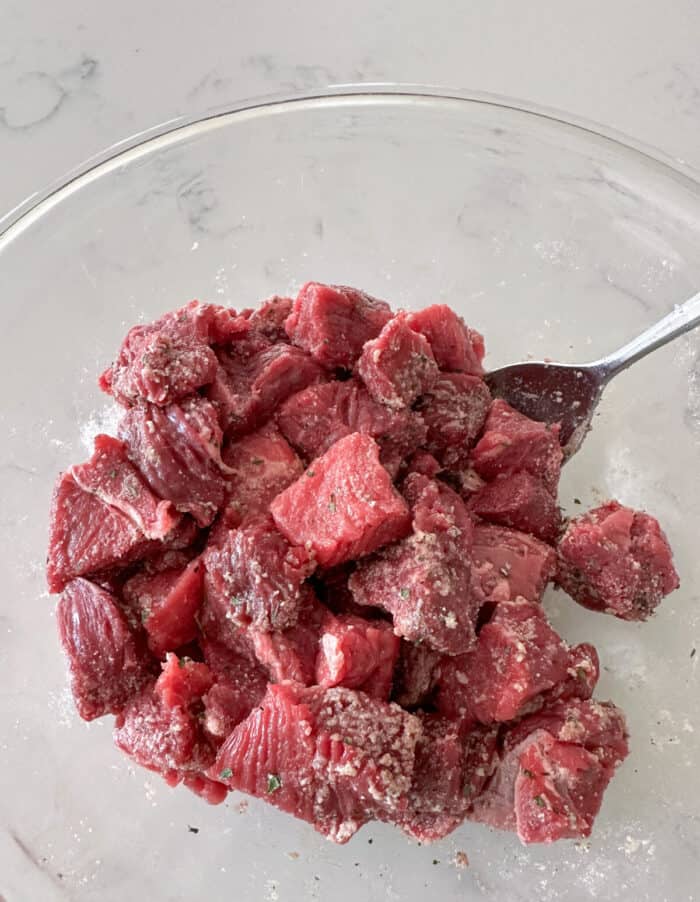 steak bites in mixing bowl with ranch seasoning