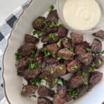 air fryer steak bites in serving dish with dipping sauce