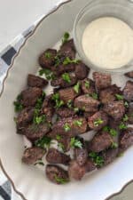 air fryer steak bites in serving dish with dipping sauce