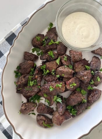 air fryer steak bites in serving dish with dipping sauce