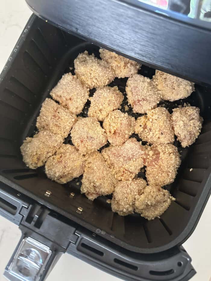 uncooked chicken nuggets in air fryer basket