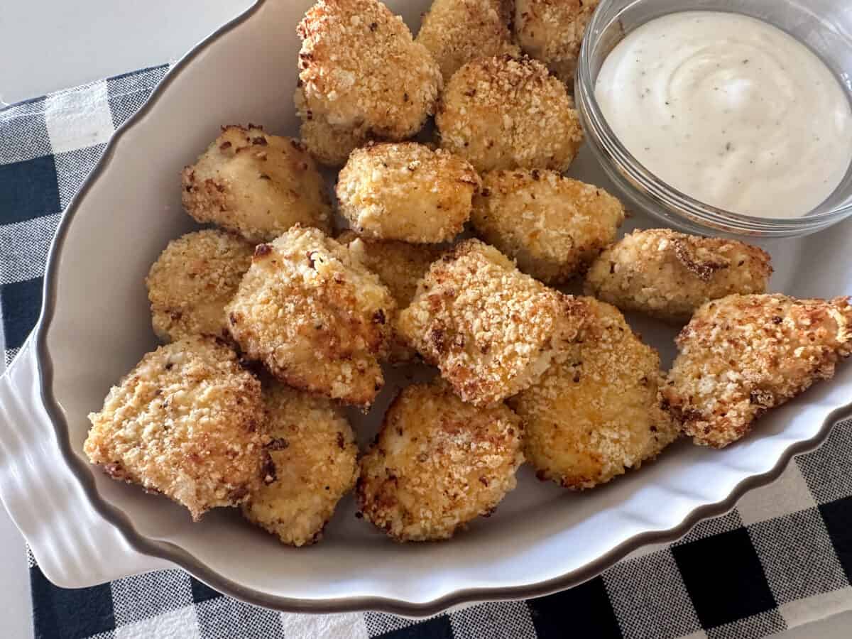 chicken nuggets in serving dish with dipping sauce.