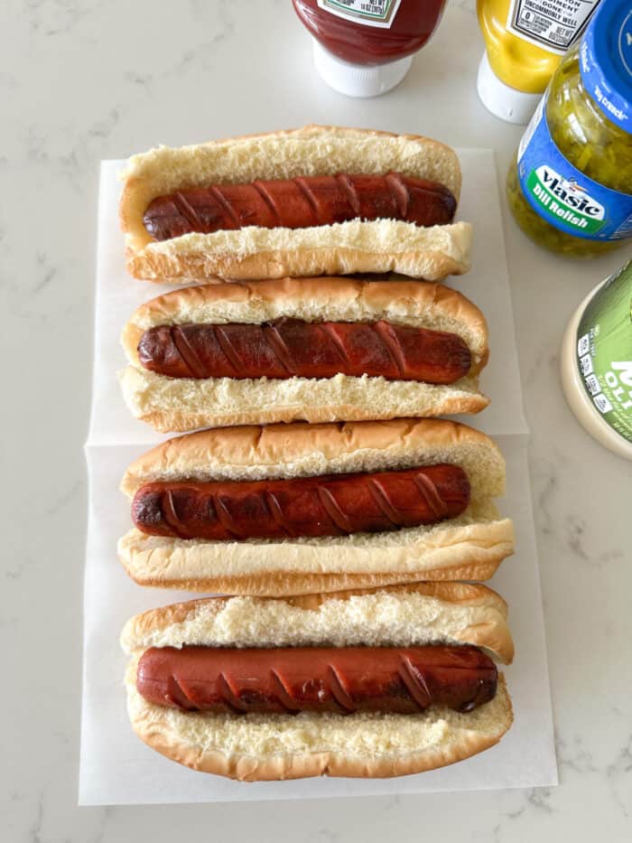 hot dogs in buns on counter top ready for toppings