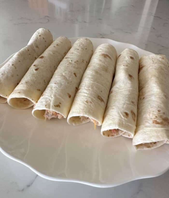 filled chicken taquitos on a plate