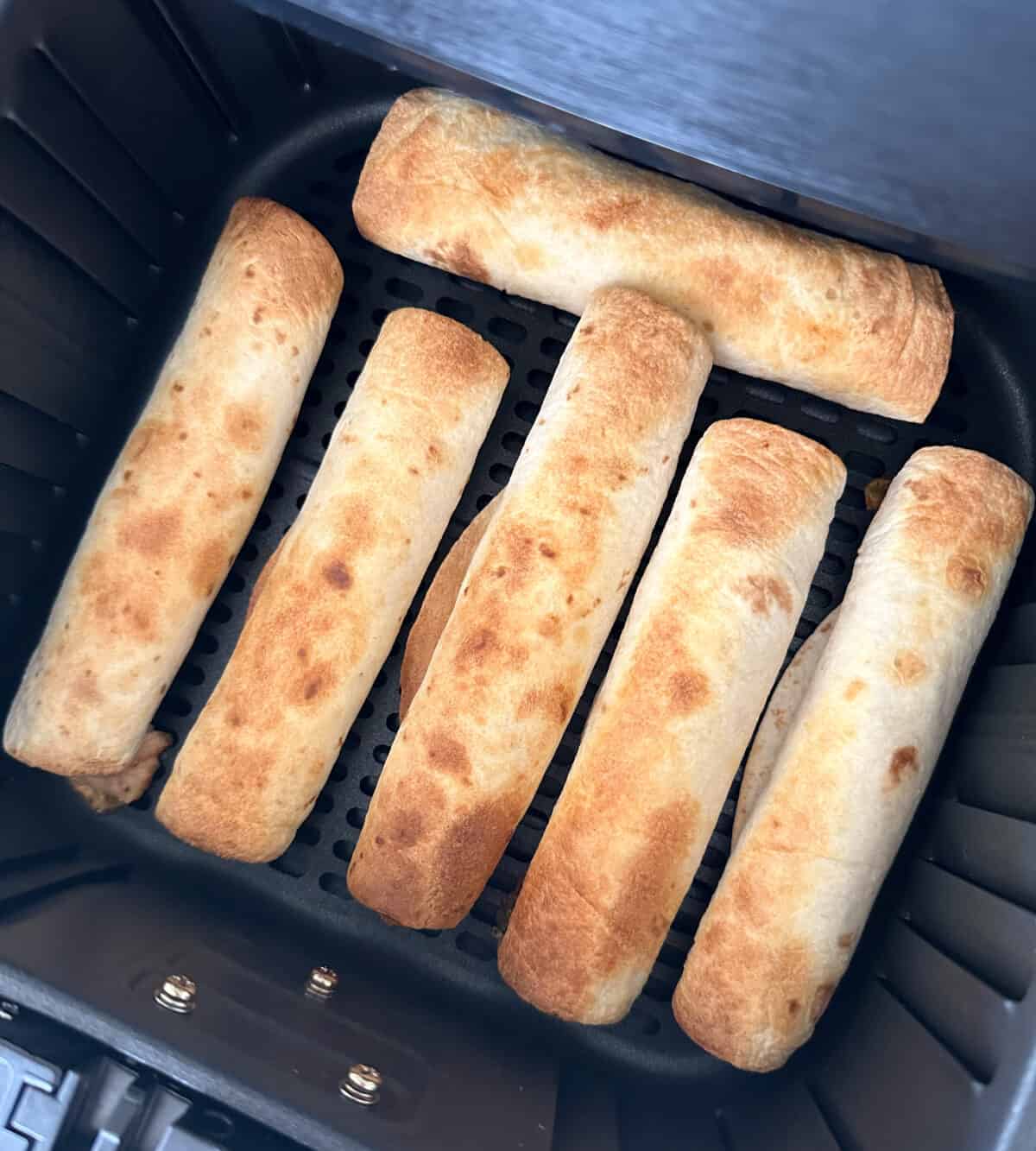 cooked taquitos in air fryer basket