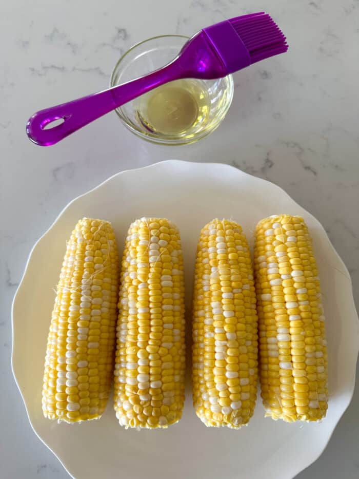 corn on the cob on plate ready for seasonings