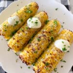corn on the cob on serving plate with butter