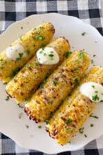 corn on the cob on serving plate with butter