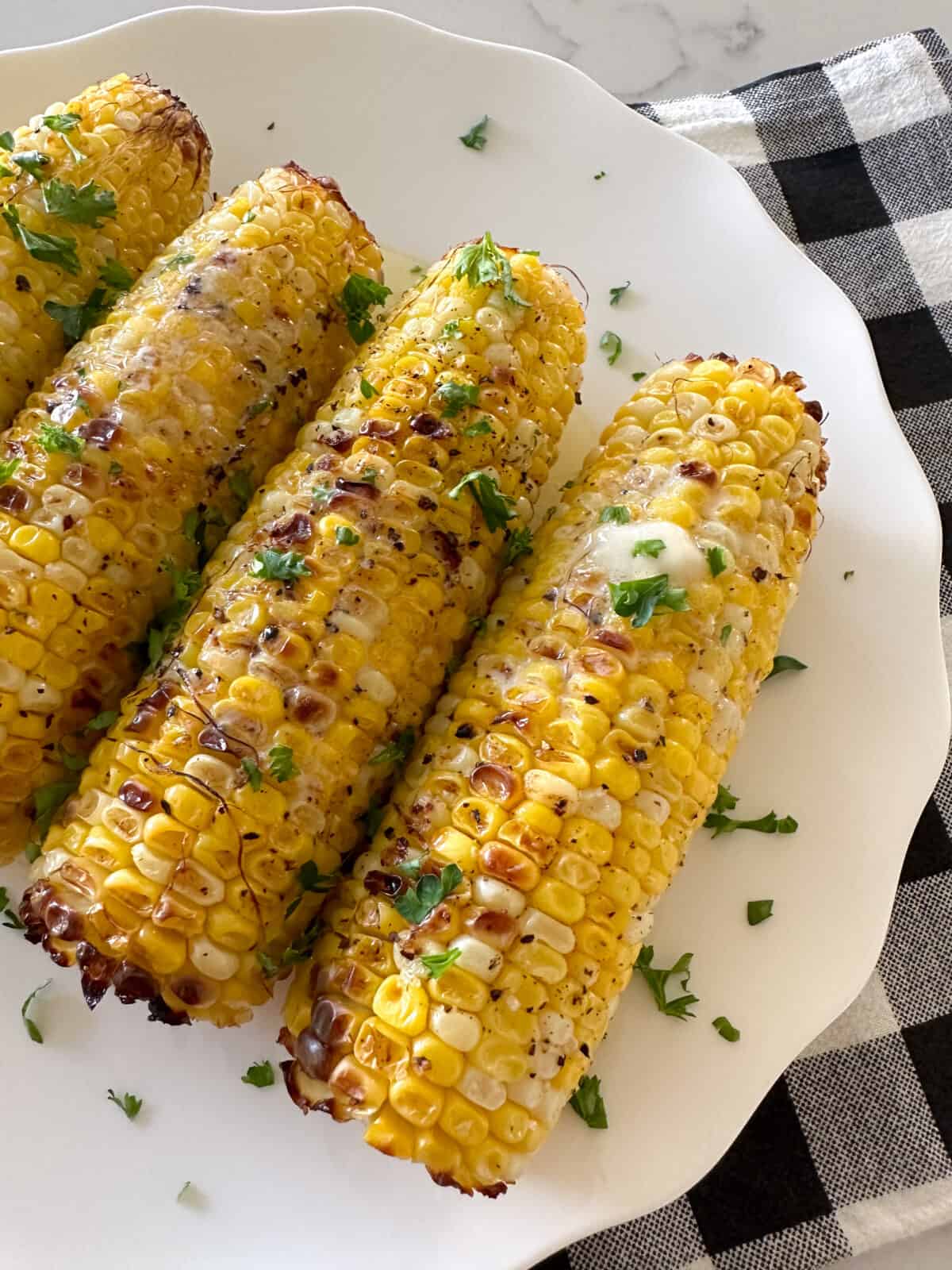 the best corn on the cob on serving plate