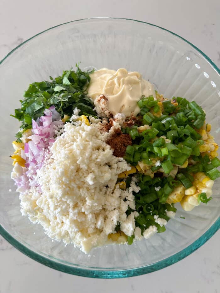 mexican street corn salad ingredients in mixing bowl