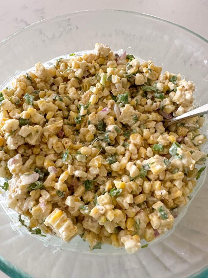 mexican street corn salad mixed in mixing bowl