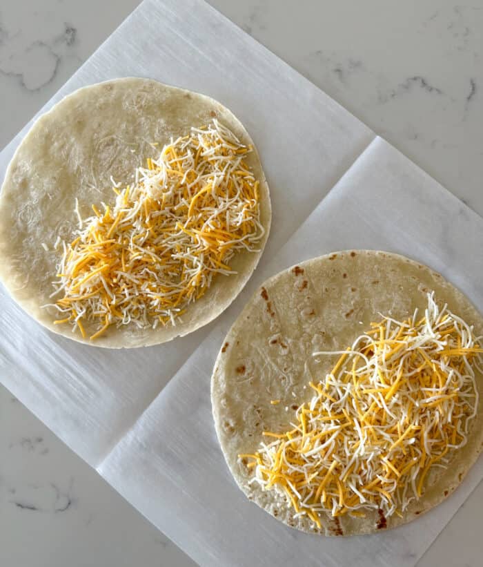 cheese placed over half of two tortillas