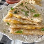 cooked quesadillas stacked on a plate