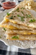 cooked quesadillas stacked on a plate