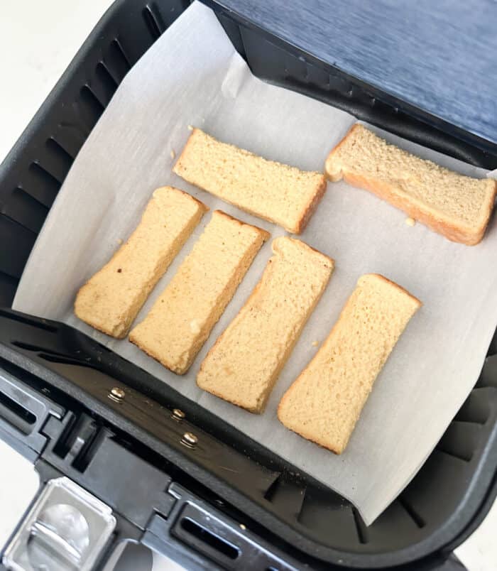 french toast dipped pieces of bread inside air fryer basket
