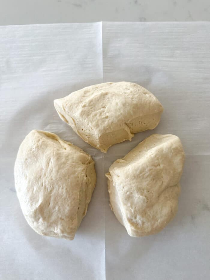 pizza dough separated into three even pieces