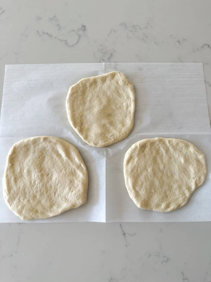 pizza dough separated into three rounds