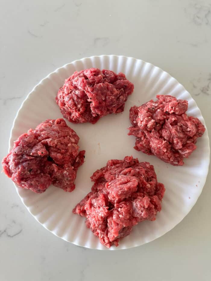 ground beef divided into fourths