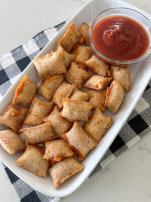 pizza rolls on serving plate with dipping sauce