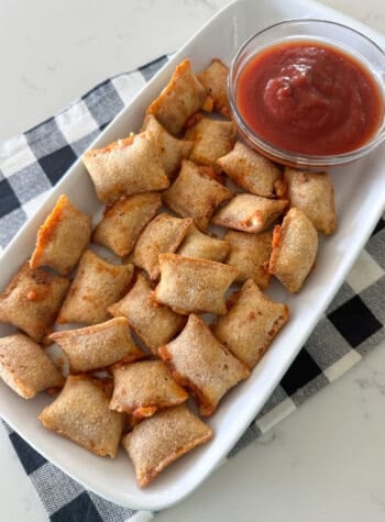 pizza rolls on serving plate with dipping sauce