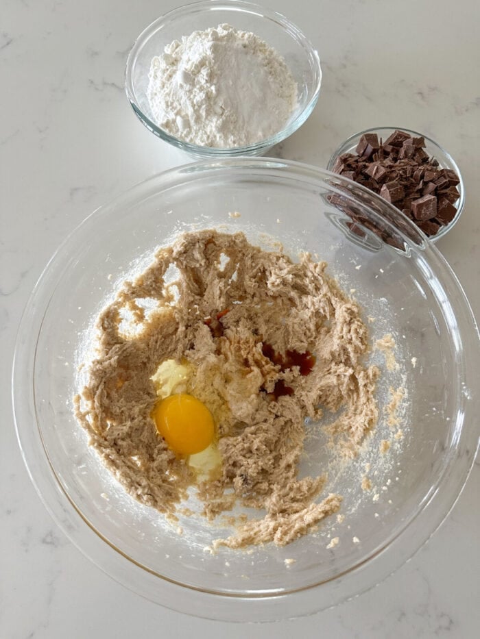eggs and vanilla added to mixing bowl of cookie dough