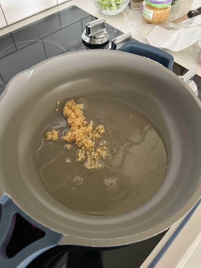 sauteeing minced garlic in skillet