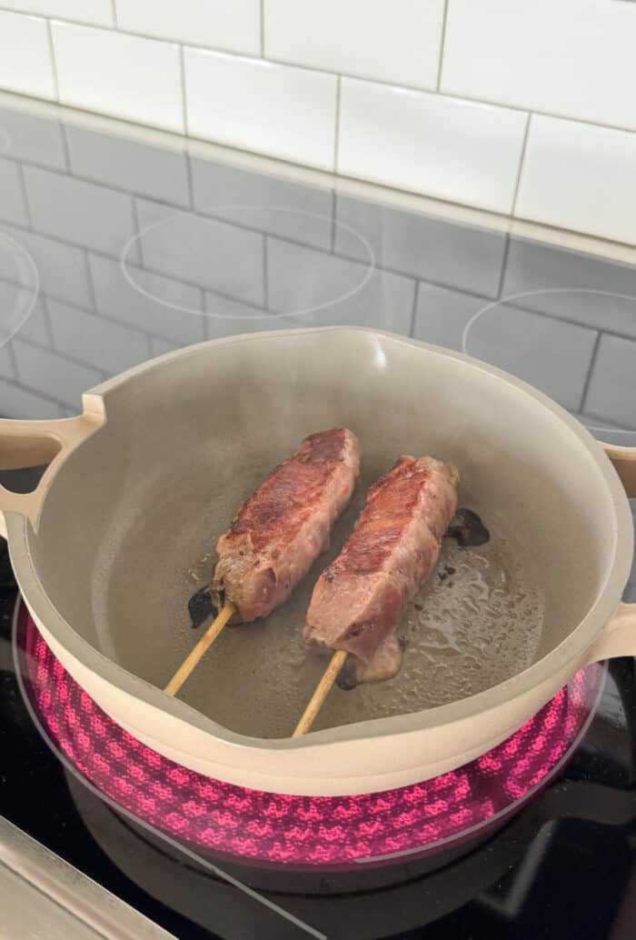 steak kabobs cooking in hot skillet