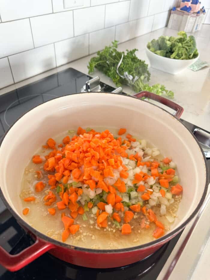 carrots celery and onion cooking in soup pot