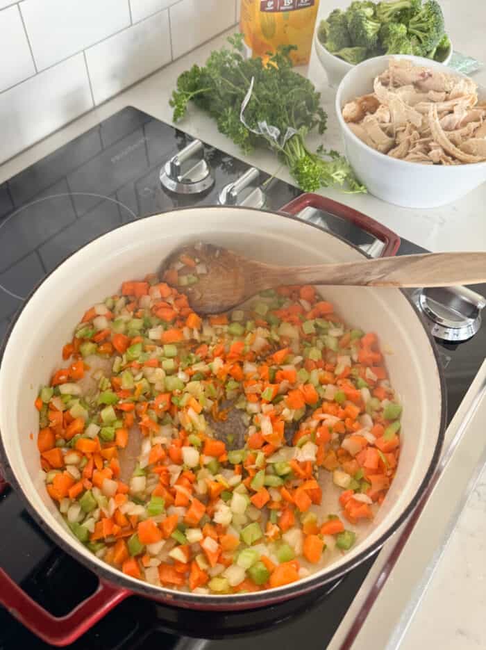 carrots celery and onion cooking in soup pot