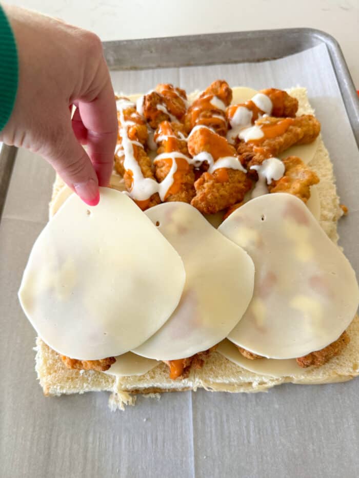 adding provolone slices on top of chicken tenders