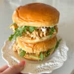 buffalo chicken sandwiches stacked on a serving plate