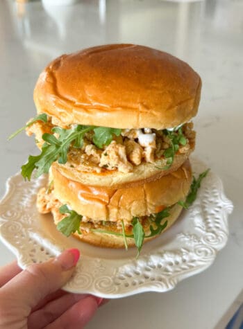 buffalo chicken sandwiches stacked on a serving plate