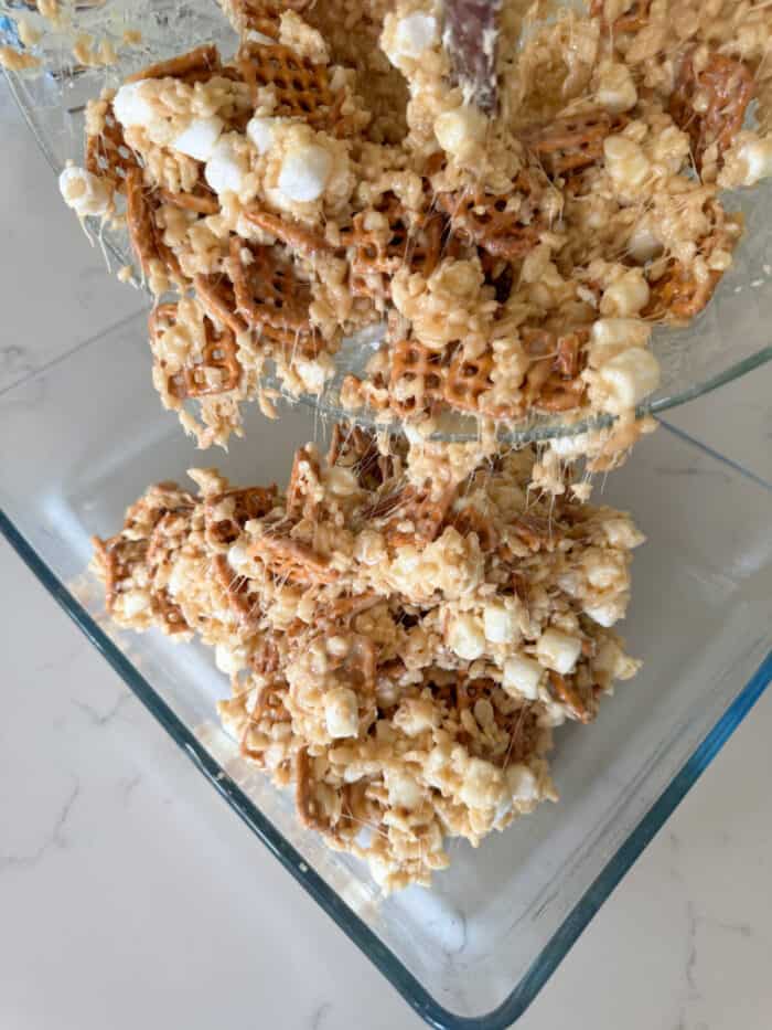 pouring rice krispie treats into baking dish