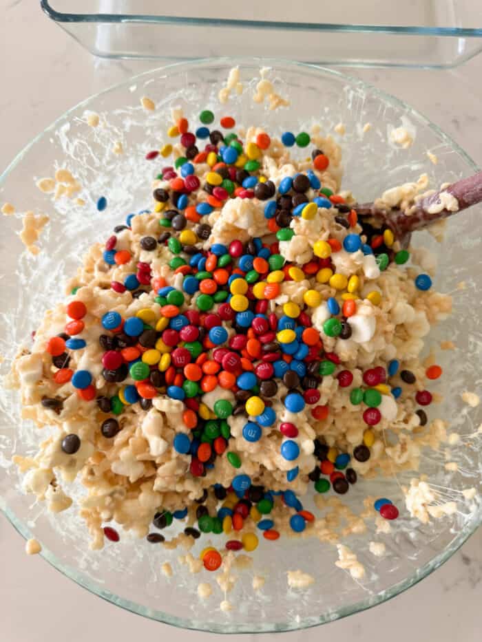 m and m's added to rice crispy treats in mixing bowl