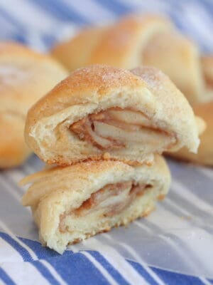 apple peanut butter crescent rolls stacked on napkin